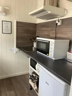 a kitchen with a counter top with a microwave at Førde Pensjonat in Førde