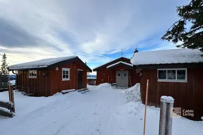 a couple of small buildings in the snow at Cozy and comfortable cabin in the center of Sjusjøen with a large terrace in Ringsaker