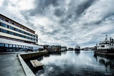 a view of a river with boats in the water at Thon Hotel Fosnavåg in Fosnavåg