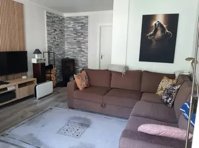 a living room with a brown couch and a tv at Apartment 2 sleeping rooms in Rjukan in Rjukan