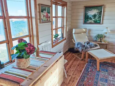 a room with a table and a chair and windows at 7 person holiday home in Averøy-By Traum in Averoy