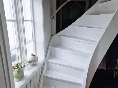 a white staircase in a room with a window at 7 person holiday home in Averøy-By Traum in Averoy