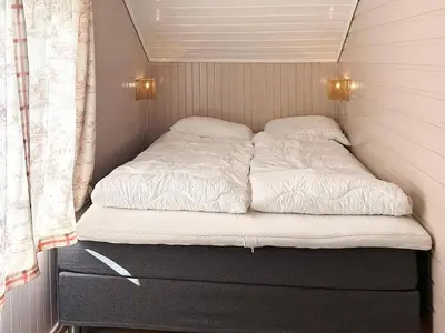 a bed in a small room in a trailer at 7 person holiday home in Averøy-By Traum in Averoy