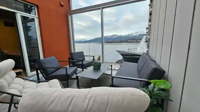 a balcony with chairs and a view of the water at West Coast Apartments Aalesund in Ålesund