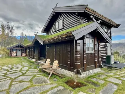 a log cabin with grass on the roof at Large cabin with spectacular views in Geilo in Geilo