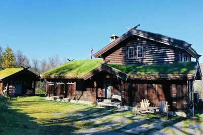 an old log cabin with a grass roof at Large cabin with spectacular views in Geilo in Geilo