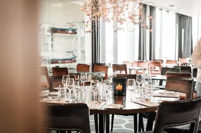 a dining room with a long table and chairs at Quality Hotel Ulstein in Ulsteinvik