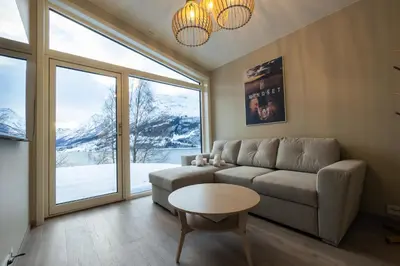 a living room with a couch and a table at Leilighet med utsikt i Loen in Stryn