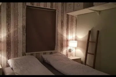 a bedroom with a bed and a large screen at Fjordcabin Panoramic view Near Bergen 3 sleepingroom in Forland