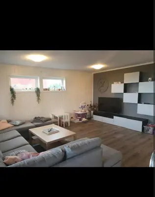 a living room with a couch and a coffee table at Hus ved sjøen in Bakken