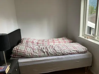 a bed with a blanket on top of it in a room at 2 mannsbolig i Hemsedal sentrum, nær skianlegget - 3 sov og 7 sengeplasser in Hemsedal