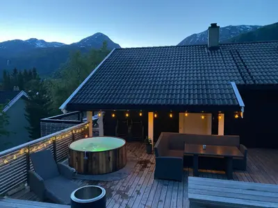 a deck with a table and a couch on a roof at 2 mannsbolig i Hemsedal sentrum, nær skianlegget - 3 sov og 7 sengeplasser in Hemsedal