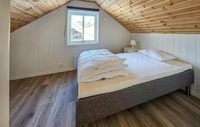 a large bed in a room with a wooden ceiling at Gorgeous Home In Rauland With Kitchen in Rauland
