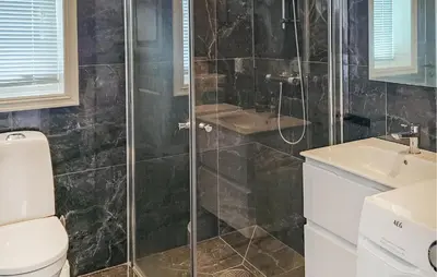 a bathroom with a shower and a toilet and a sink at Gorgeous Home In Rauland With Kitchen in Rauland