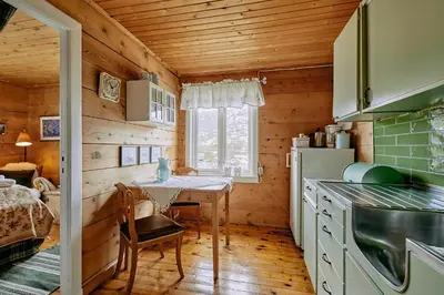 a kitchen with a table in a wooden house at Flatheim in Viksdalen