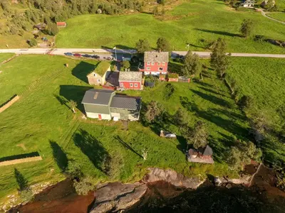 an aerial view of a house on a green field at Flatheim in Viksdalen