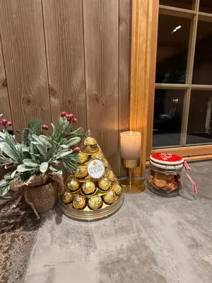 a table with a candle and a pile of gold coins at Trysil Moderna Lodge in Trysil