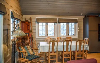 a kitchen with a table and chairs and a refrigerator at Lovely Home In Geilo With Wifi in Geilo