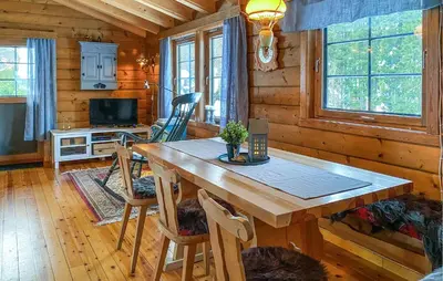 a dining room with a wooden table in a cabin at Lovely Home In Stranda With Wifi in Stranda