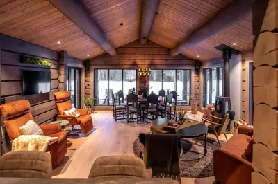 a living room filled with furniture and a dining room at ElveRo Lodge in Trysil