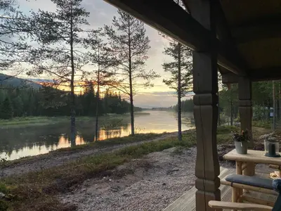 a view of a river from a porch of a house at ElveRo Lodge in Trysil