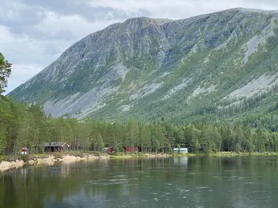 a view of a mountain and a lake with trees at ElveRo Lodge in Trysil