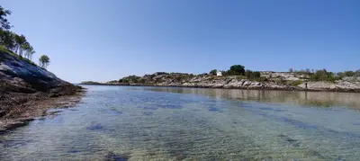 a river with rocks on the side of it at Edvinstua Solbakken Feriehus in Fevåg