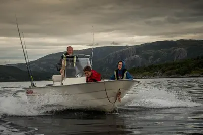 a group of people on a boat in the water at Edvinstua Solbakken Feriehus in Fevåg