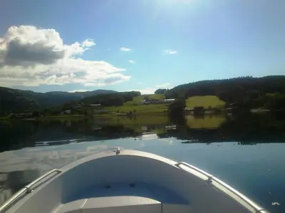 a view of a lake from the bow of a boat at Apartment Solbakken Feriehus in Fevåg
