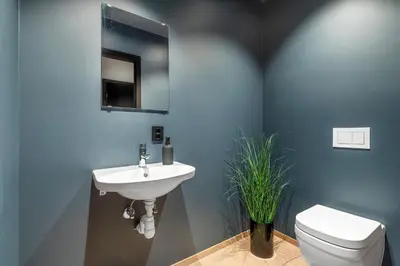 a bathroom with a white sink and a toilet at Toppleilighet på bryggen i Sogndal med fantastisk utsikt in Sogndal