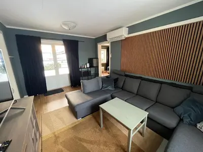 a living room with a couch and a table at Stue, soverom og bad in Åmot