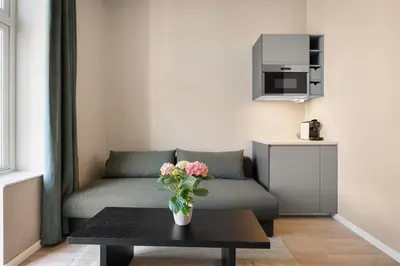 a living room with a couch and a table at Bohemian Hotel - Self-Service in Bergen