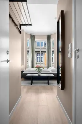 a hallway with a room with a bed and a window at Bohemian Hotel - Self-Service in Bergen