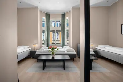 a living room with two beds and a table at Bohemian Hotel - Self-Service in Bergen