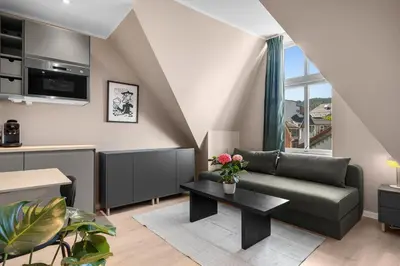 a living room with a couch and a table at Bohemian Hotel - Self-Service in Bergen