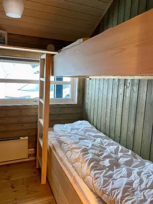 an empty bunk bed in a cabin with a window at Hito - cabin between Flå and Eggedal in Flå