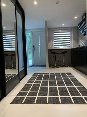 a living room with a black and white carpet at Ekskluzywny hybel w zaciszu in Kristiansund