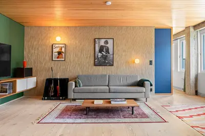 a living room with a couch and a coffee table at Unique gem overlooking the world famous Bryggen in Bergen
