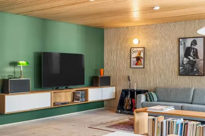 a living room with a couch and a flat screen tv at Unique gem overlooking the world famous Bryggen in Bergen
