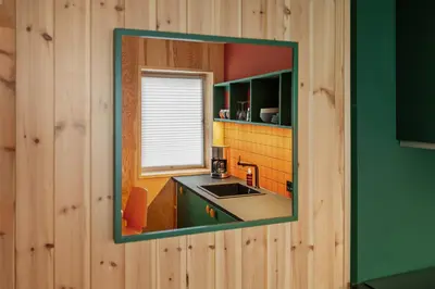 a mirror hanging on a wall in a kitchen at Unique Studio I Custom Built I 500 Meters From Bryggen in Bergen