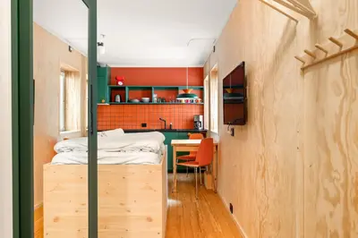a small room with a bed and a table at Unique Studio I Custom Built I 500 Meters From Bryggen in Bergen