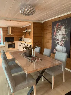 a dining room with a wooden table and chairs at Villa Flo in Stryn