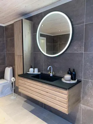 a bathroom with a sink and a mirror at Villa Flo in Stryn