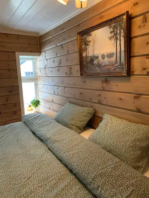a bedroom with a bed and a picture on the wall at Villa Flo in Stryn