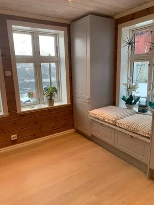a room with two windows and a bench in a room at Villa Flo in Stryn