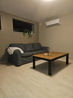 a living room with a couch and a coffee table at Leilighet nær flyplass og Ålesund sentrum in Ytterland