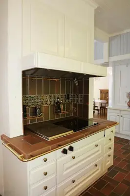 a kitchen with white cabinets and a stove top oven at Luxury Historic Villa with private coastline in Bergen