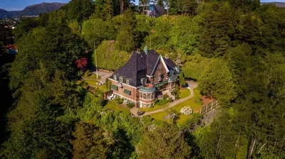 an aerial view of a large house on a hill at Luxury Historic Villa with private coastline in Bergen