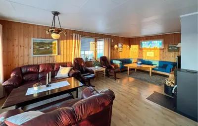 a living room with leather couches and a table at Amazing Home In Svingvoll in Svingvoll