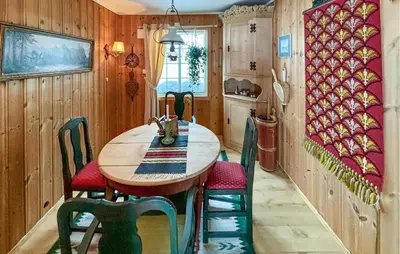 a dining room with a wooden table and chairs at Amazing Home In Svingvoll in Svingvoll